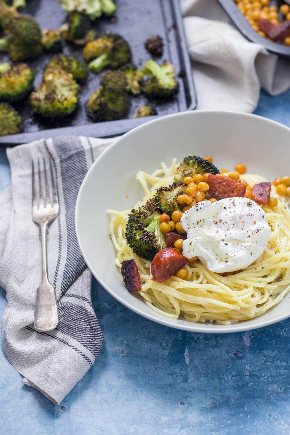 A simple weeknight meal packed with garlicky flavour and topped with delicious roasted broccoli, crispy chickpeas and chorizo. Finished with a poached egg.