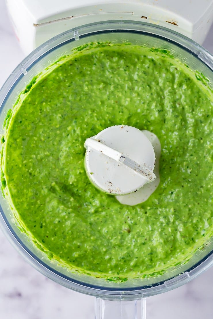 Overhead shot of spinach pesto with feta in a blender