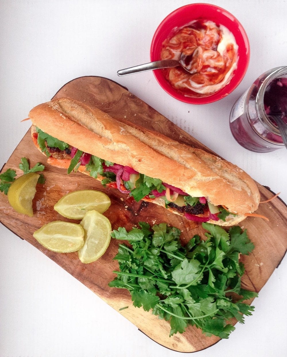 This Korean pork banh mi has meatballs cooked until crisp on the outside then topped with gochujang mayo, carrot, cucumber and quick pickled onions.