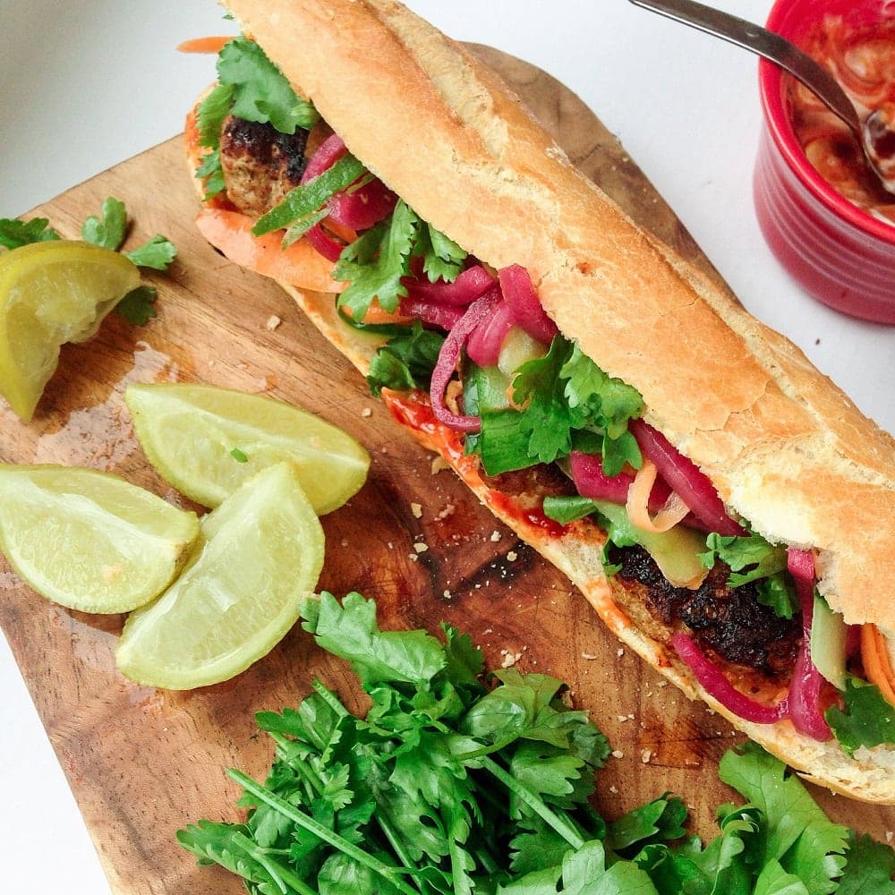 This Korean pork banh mi has meatballs cooked until crisp on the outside then topped with gochujang mayo, carrot, cucumber and quick pickled onions.