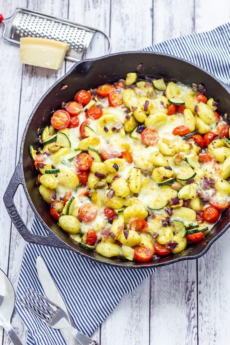 Summer gnocchi skillet on a white wooden background