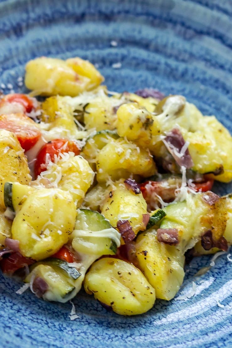 Portion of summer gnocchi skillet in a blue bowl