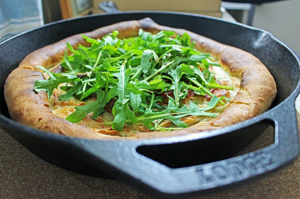 This simple skillet pizza makes perfect use of your cast iron skillet & combines salty prosciutto with creamy mozzarella & garlic oil for a delicious dinner.