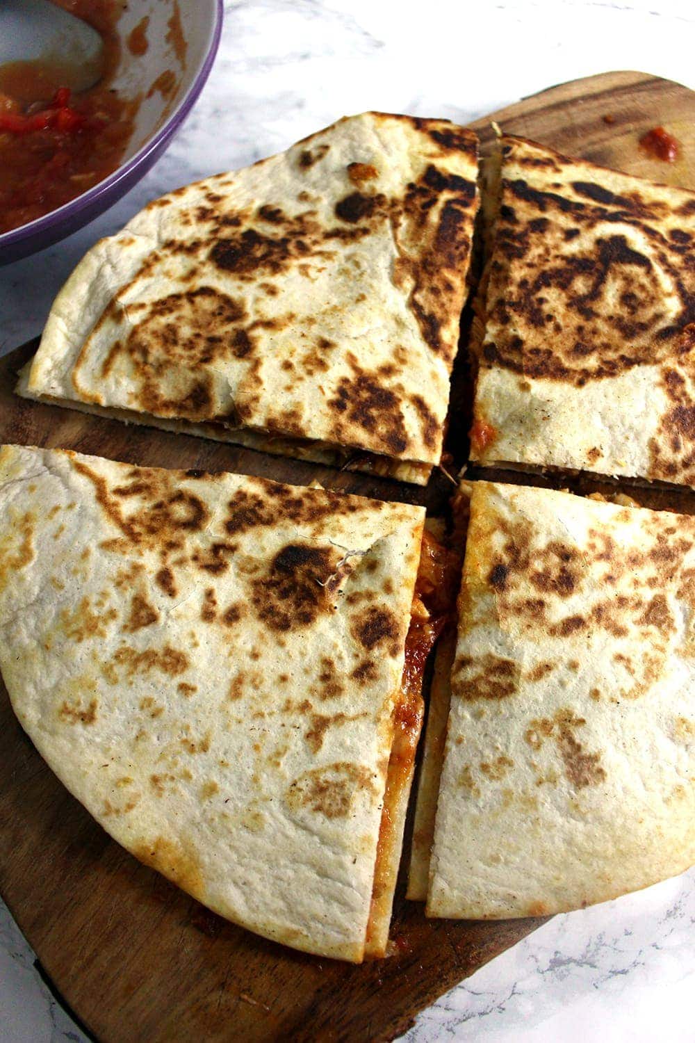 These slow cooker chipotle chicken quesadillas are the perfect weeknight dinner. At the end of the day just shred your chicken and fry up some quesadillas!