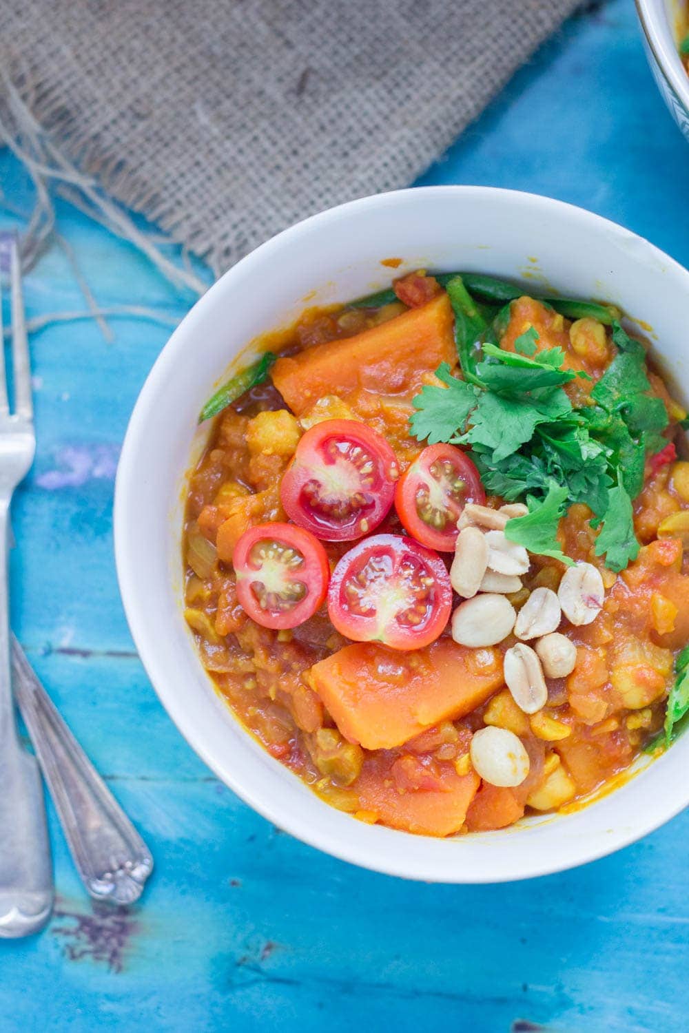 This peanut and sweet potato stew is spicy, filling and delicious. Add all your favourite toppings and serve with a healthy portion of rice or other grain. #vegetarian #comfortfood #healthy