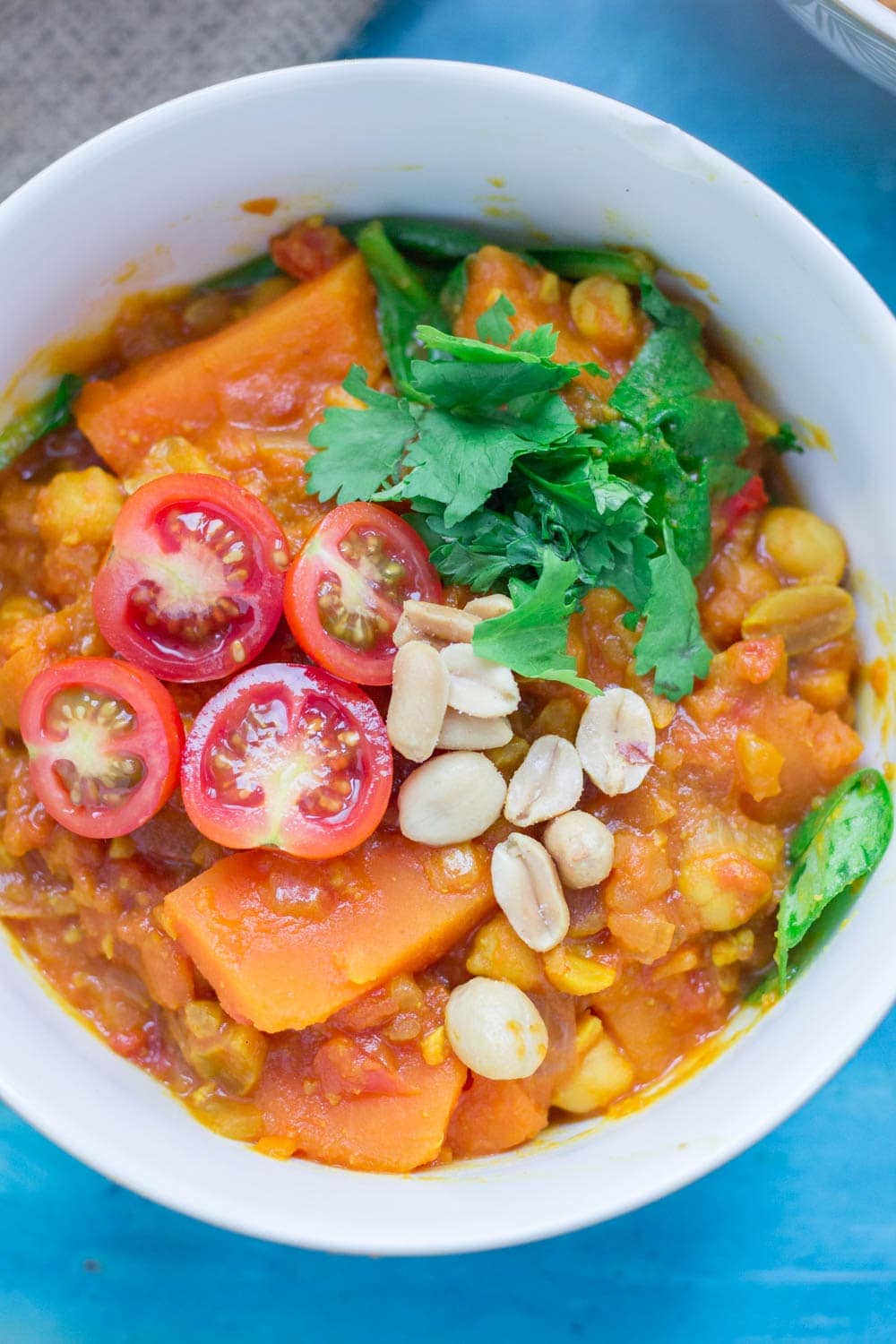 This peanut and sweet potato stew is spicy, filling and delicious. Add all your favourite toppings and serve with a healthy portion of rice or other grain. #vegetarian #comfortfood #healthy