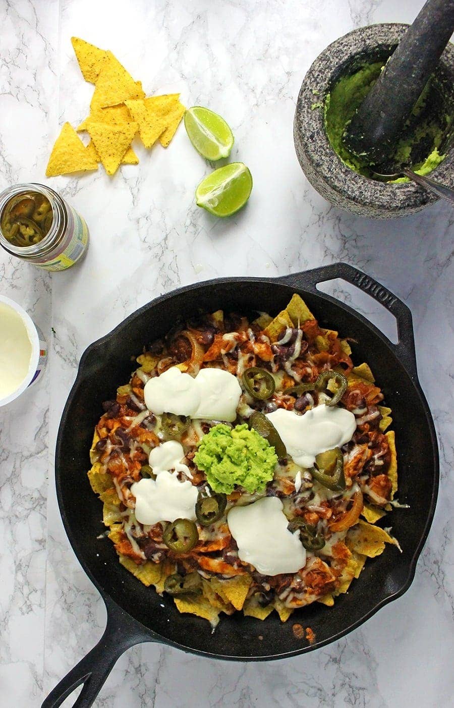 These chicken chili nachos are a perfect party dish! Surprisingly quick to put together, you can make them even easier by using pre-cooked chicken. 