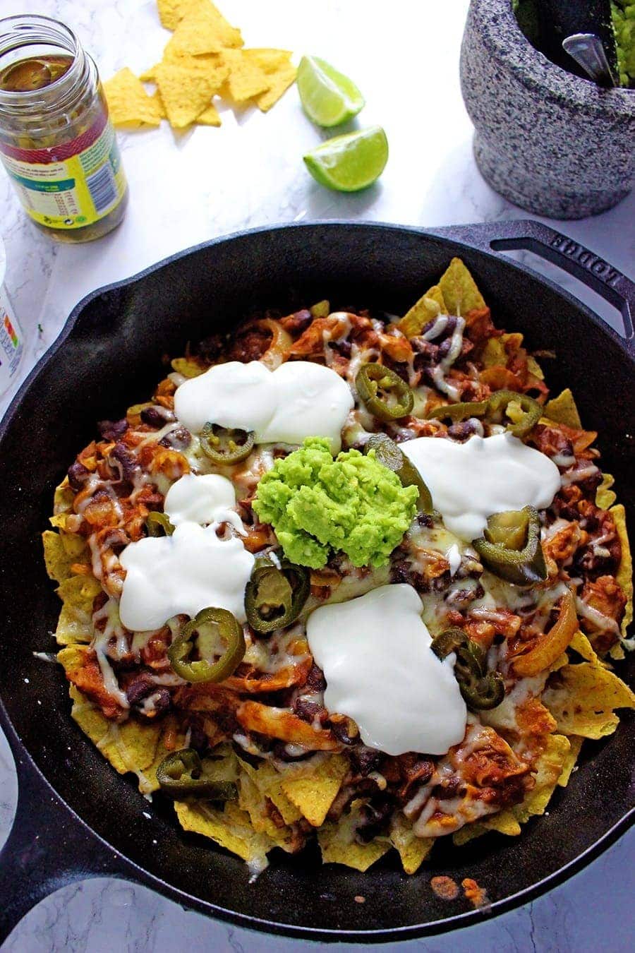 These chicken chili nachos are a perfect party dish! Surprisingly quick to put together, you can make them even easier by using pre-cooked chicken.