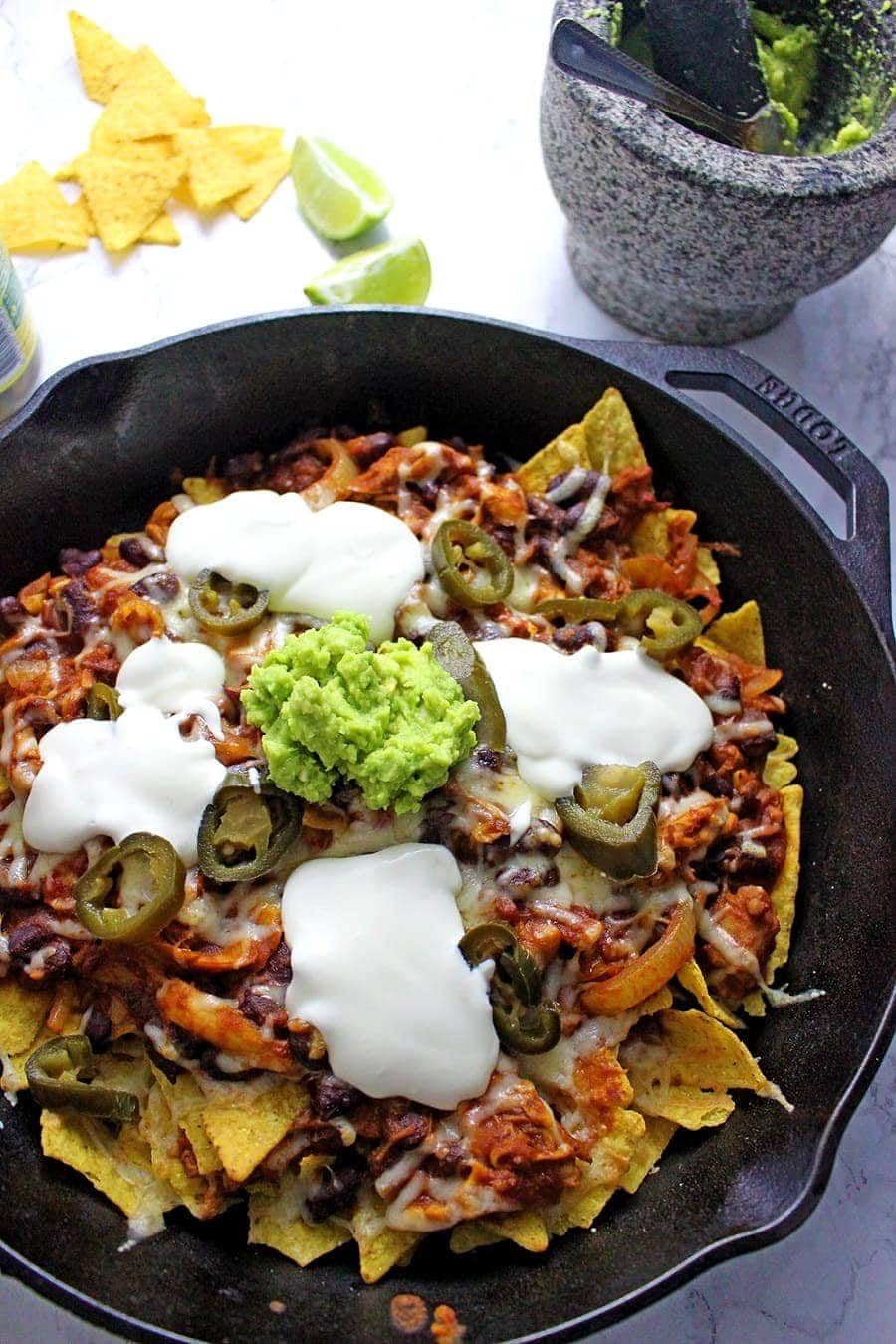 These chicken chili nachos are a perfect party dish! Surprisingly quick to put together, you can make them even easier by using pre-cooked chicken. 