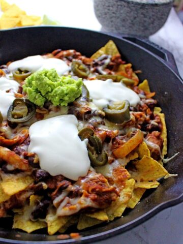 These chicken chili nachos are a perfect party dish! Surprisingly quick to put together, you can make them even easier by using pre-cooked chicken.