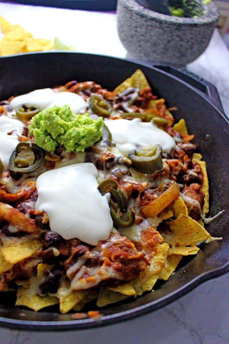 These chicken chili nachos are a perfect party dish! Surprisingly quick to put together, you can make them even easier by using pre-cooked chicken. 