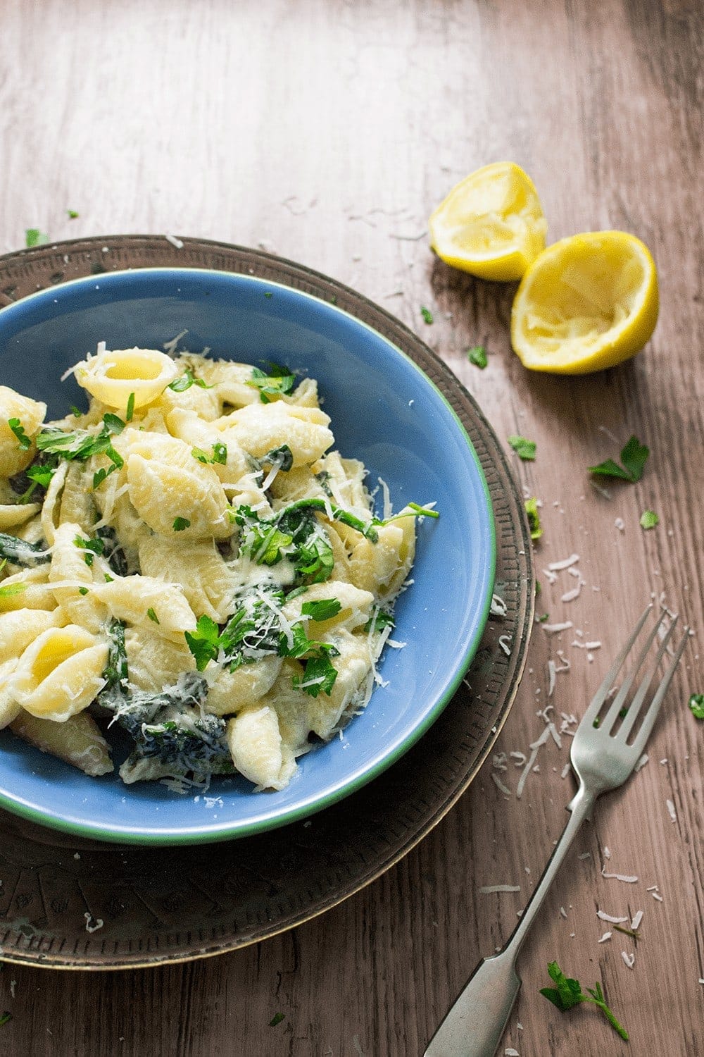 Blue bowl of sour cream pasta on a wooden background