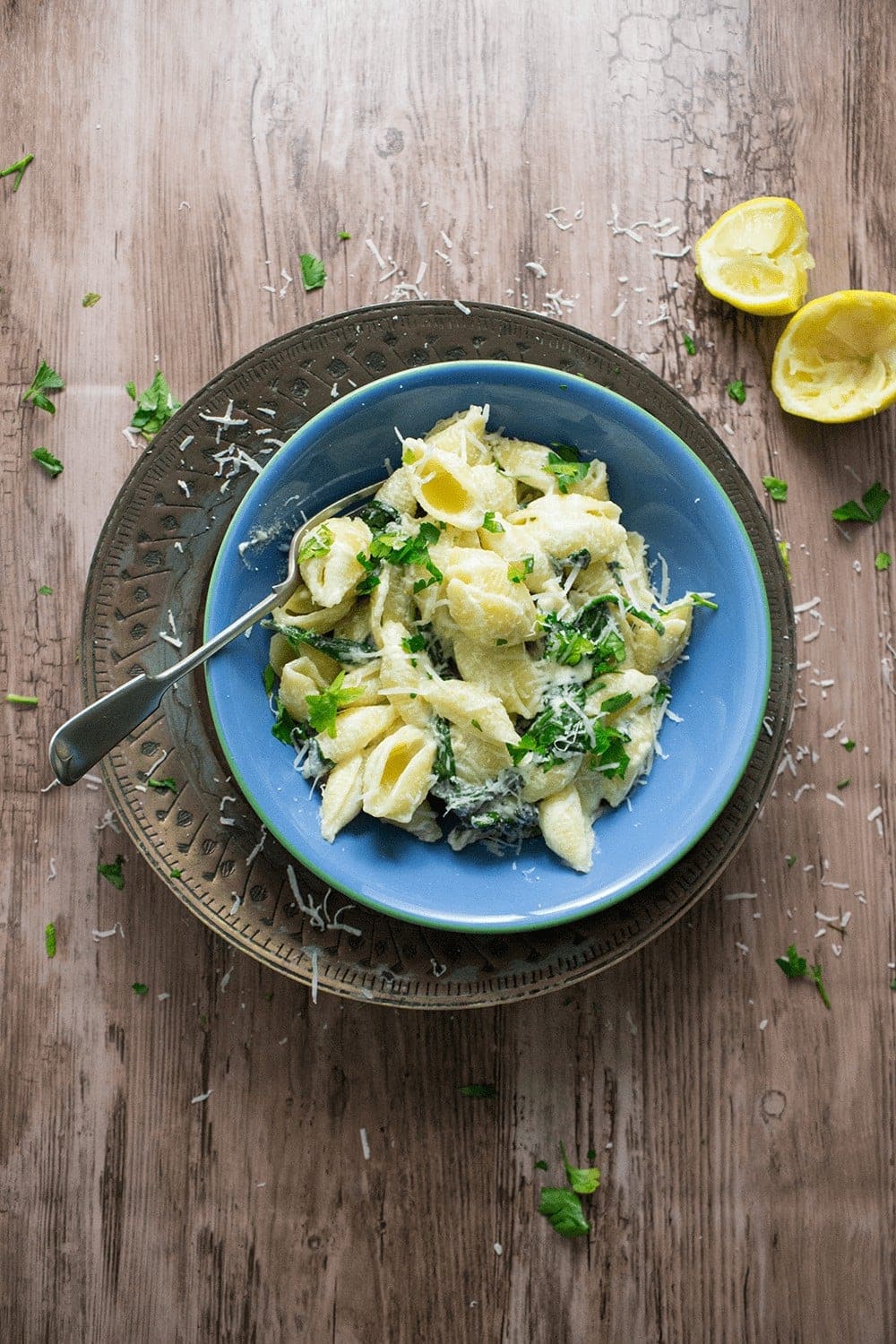 Overhead shot of lemon garlic sour cream pasta on a wooden background