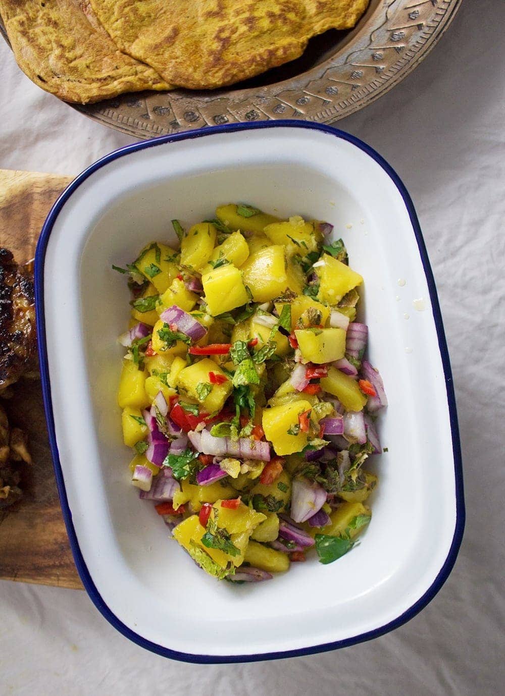 This jerk chicken is sweet and spicy, it tastes amazing served with a mango salsa and turmeric roti. Rice & peas is the perfect base for all this deliciousness!