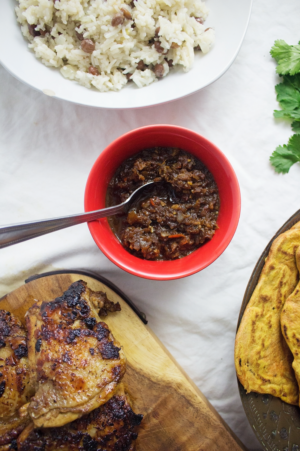 This jerk chicken is sweet and spicy, it tastes amazing served with a mango salsa and turmeric roti. Rice & peas is the perfect base for all this deliciousness!