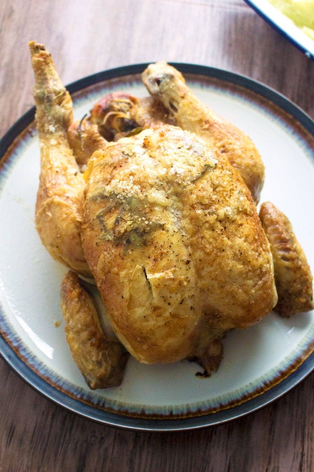 This deliciously succulent roast chicken is flavoured with rosemary, lemon and garlic. Rub the skin with butter and salt to get it extra crispy!