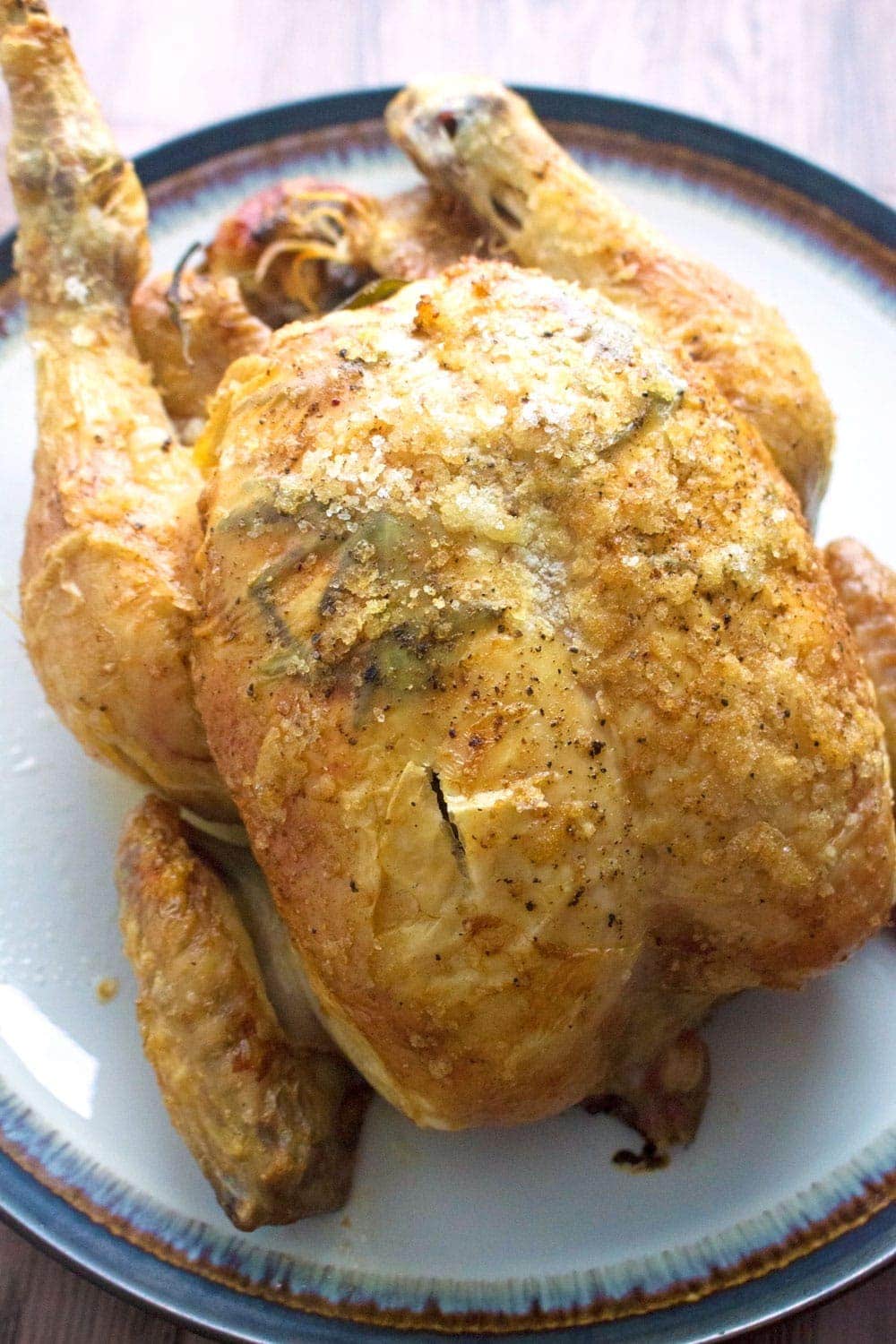 This deliciously succulent roast chicken is flavoured with rosemary, lemon and garlic. Rub the skin with butter and salt to get it extra crispy!