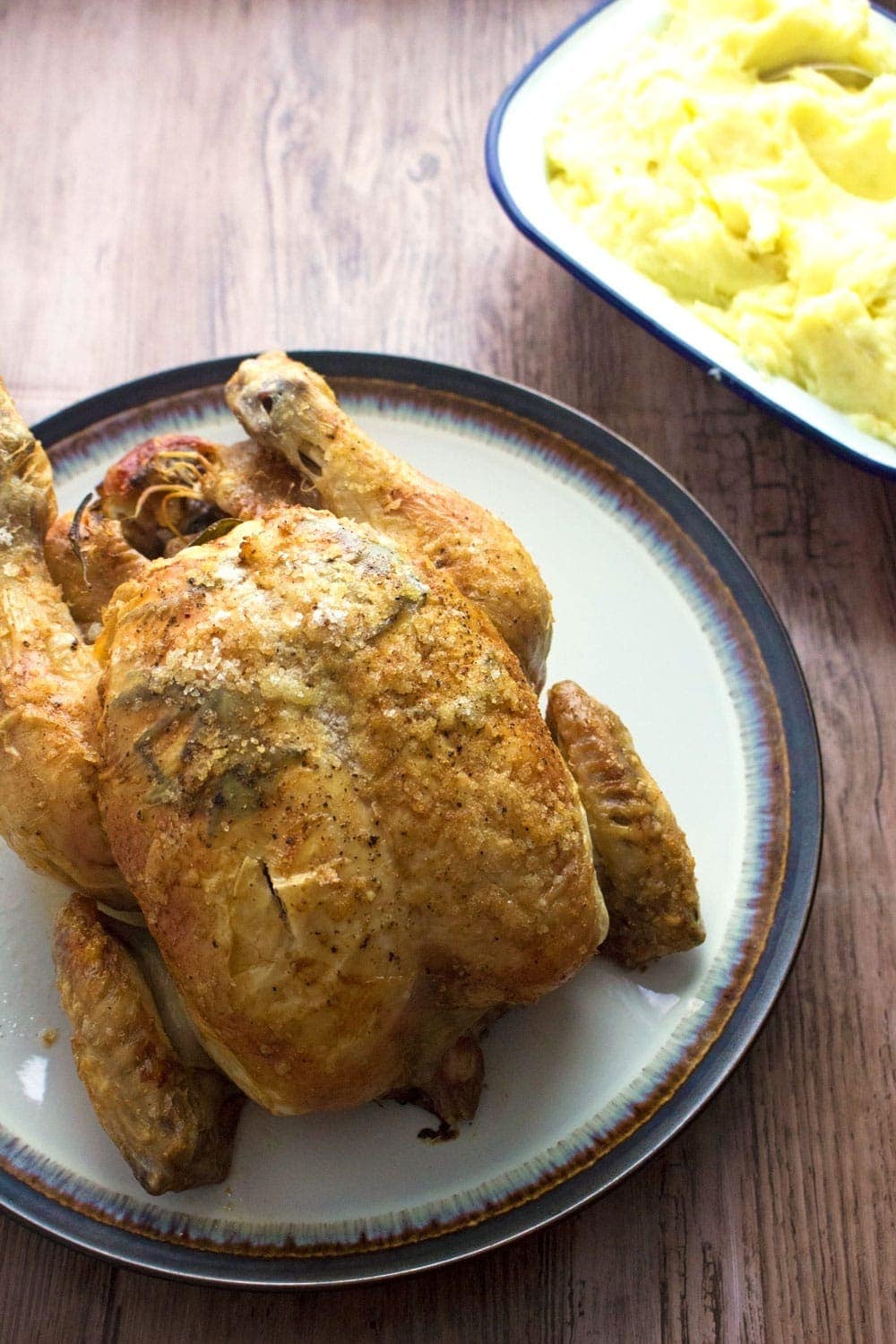 This deliciously succulent roast chicken is flavoured with rosemary, lemon and garlic. Rub the skin with butter and salt to get it extra crispy!