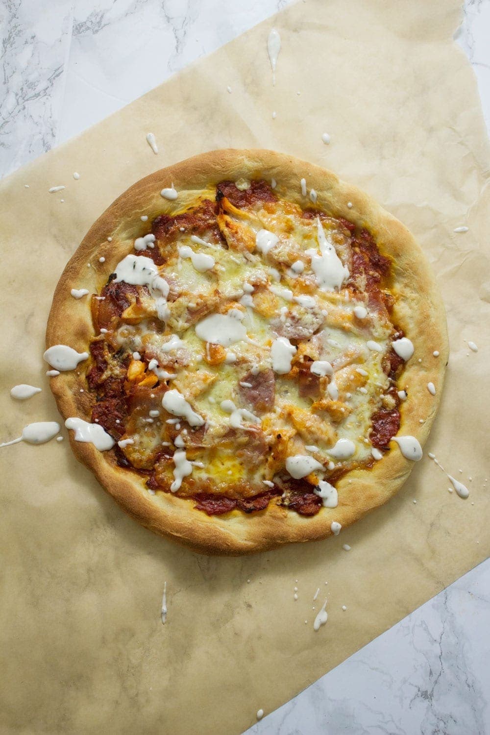 This sriracha chicken bacon ranch pizza is the perfect combination of spicy and salty with a hint of creamy ranch to finish things off!