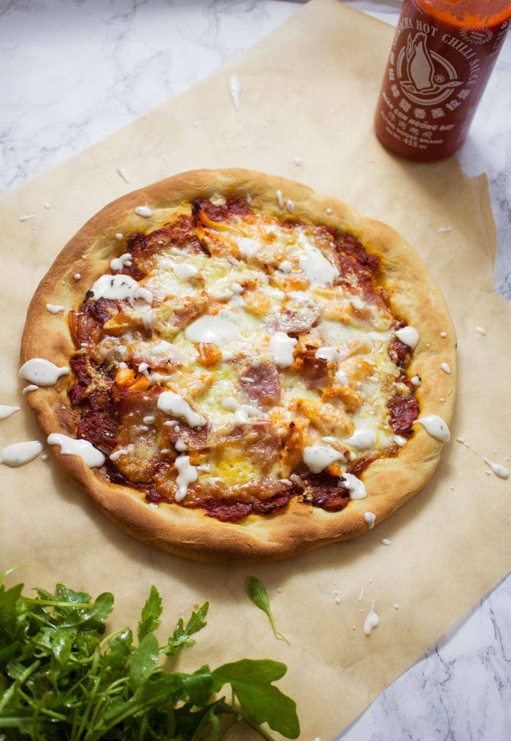 This sriracha chicken bacon ranch pizza is the perfect combination of spicy and salty with a hint of creamy ranch to finish things off!