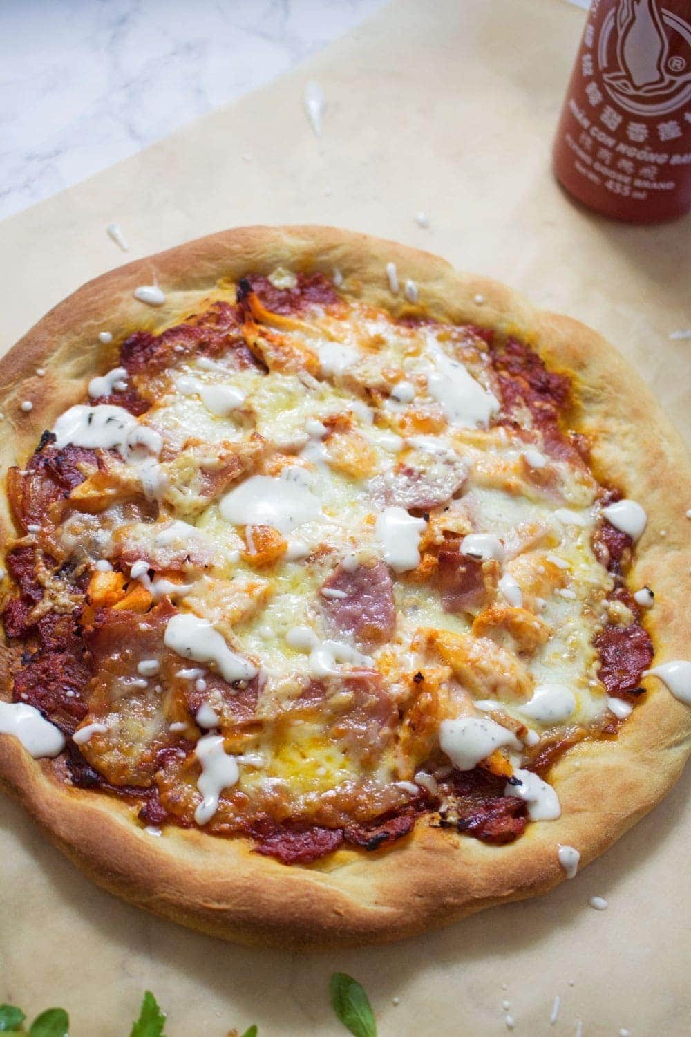 This sriracha chicken bacon ranch pizza is the perfect combination of spicy and salty with a hint of creamy ranch to finish things off!