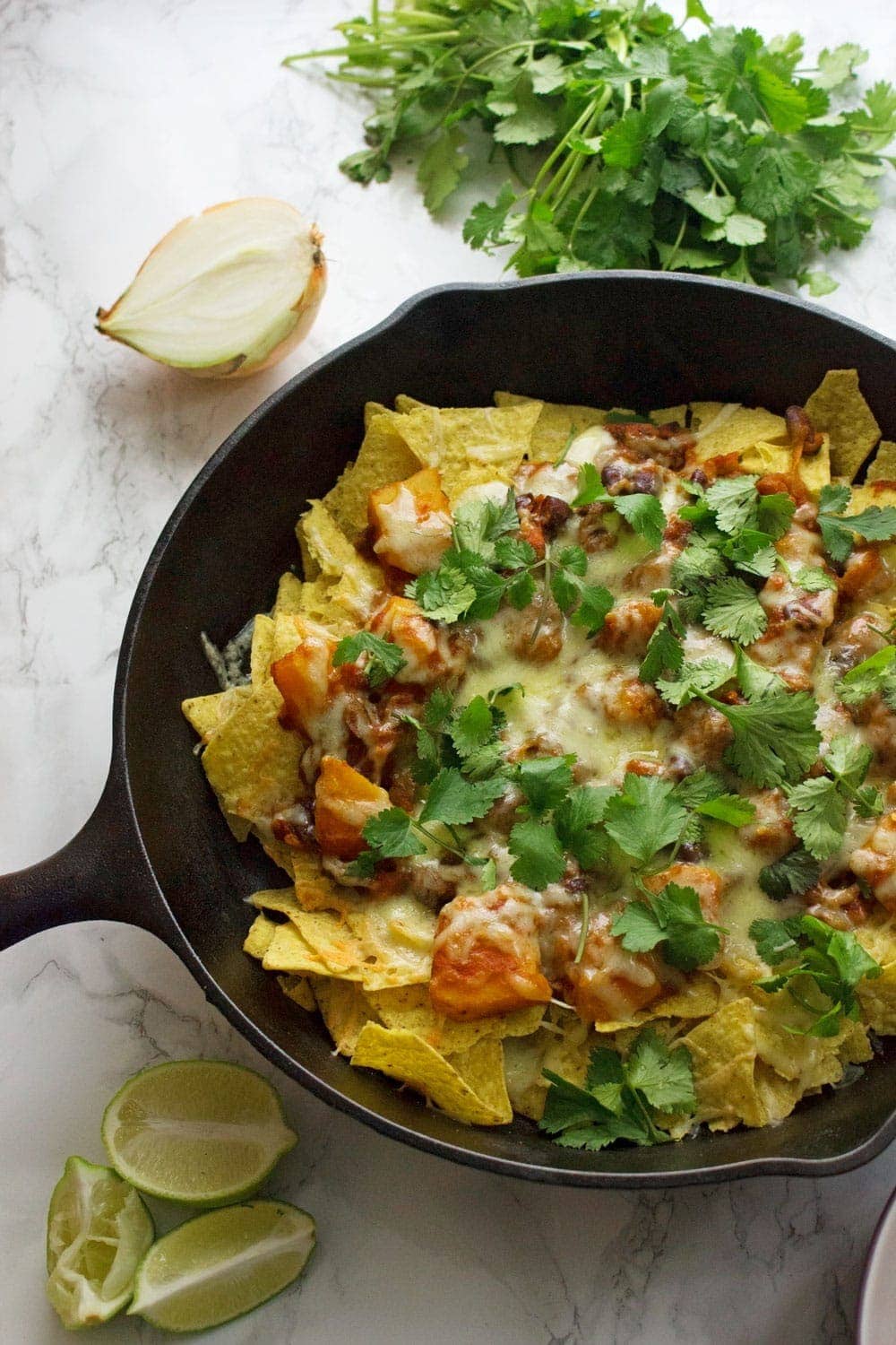 This healthy butternut squash chilli makes the perfect topping for these vegetarian nachos. Add all your favourite toppings for a delicious twist on a classic!