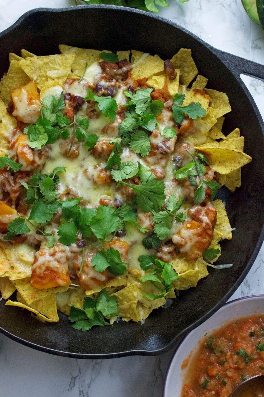 This healthy butternut squash chilli makes the perfect topping for these vegetarian nachos. Add all your favourite toppings for a delicious twist on a classic!