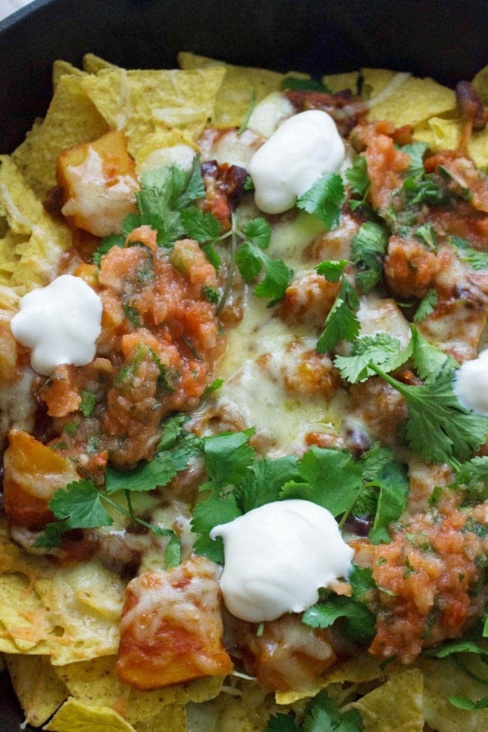 This healthy butternut squash chilli makes the perfect topping for these vegetarian nachos. Add all your favourite toppings for a delicious twist on a classic!