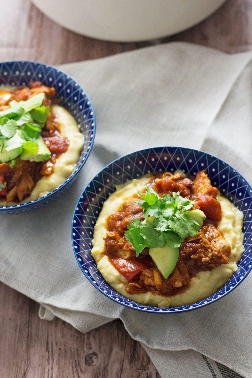 These spicy chicken burrito bowls with cheesy polenta are extreme comfort food and surprisingly quick to make! They're the perfect weeknight winter dinner.