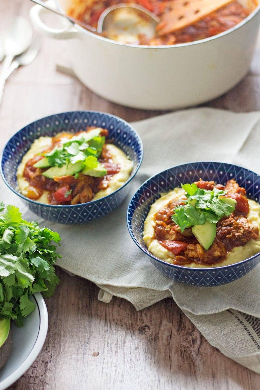 These spicy chicken burrito bowls with cheesy polenta are extreme comfort food and surprisingly quick to make! They're the perfect weeknight winter dinner.