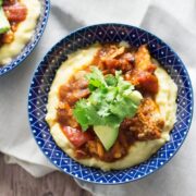 These spicy chicken burrito bowls with cheesy polenta are extreme comfort food and surprisingly quick to make! They're the perfect weeknight winter dinner.