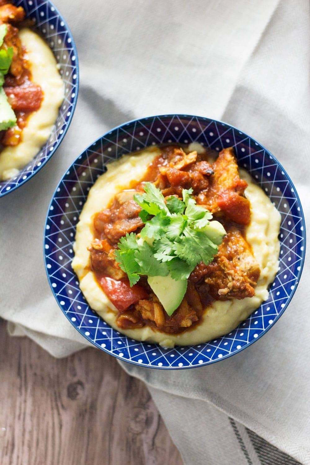 These spicy chicken burrito bowls with cheesy polenta are extreme comfort food and surprisingly quick to make! They're the perfect weeknight winter dinner.