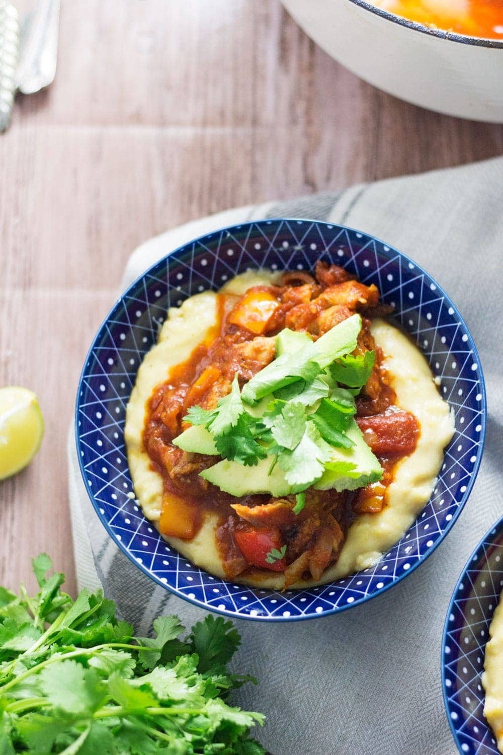 These spicy chicken burrito bowls with cheesy polenta are extreme comfort food and surprisingly quick to make! They're the perfect weeknight winter dinner.