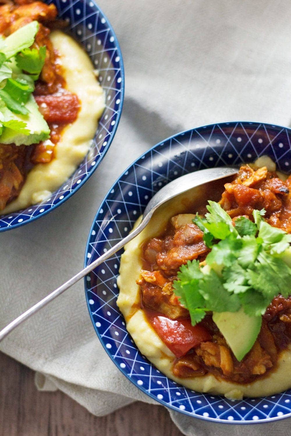 These spicy chicken burrito bowls with cheesy polenta are extreme comfort food and surprisingly quick to make! They're the perfect weeknight winter dinner.