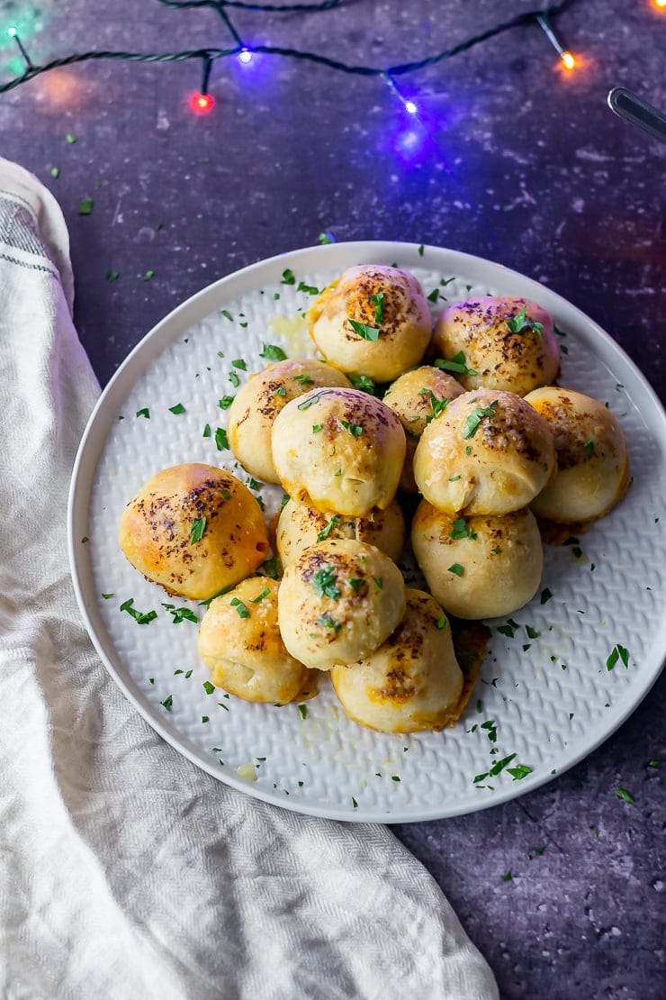 Overhead shot of pesto mozzarella stuffed dough balls on a dark background