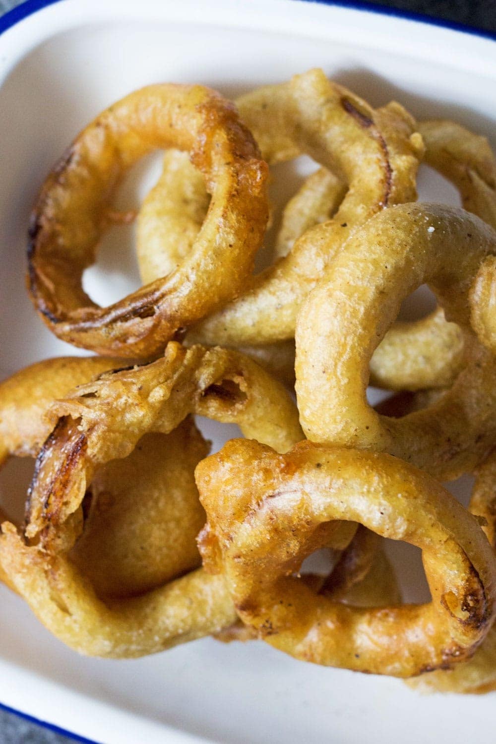 This Caribbean style fish and chips is made up of rum battered fish, sweet potato fries, jerk onion rings and an incredible coconut curry sauce! 