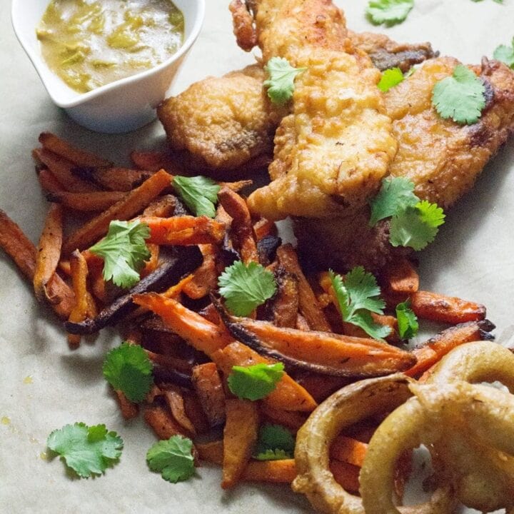 This Caribbean style fish and chips is made up of rum battered fish, sweet potato fries, jerk onion rings and an incredible coconut curry sauce!