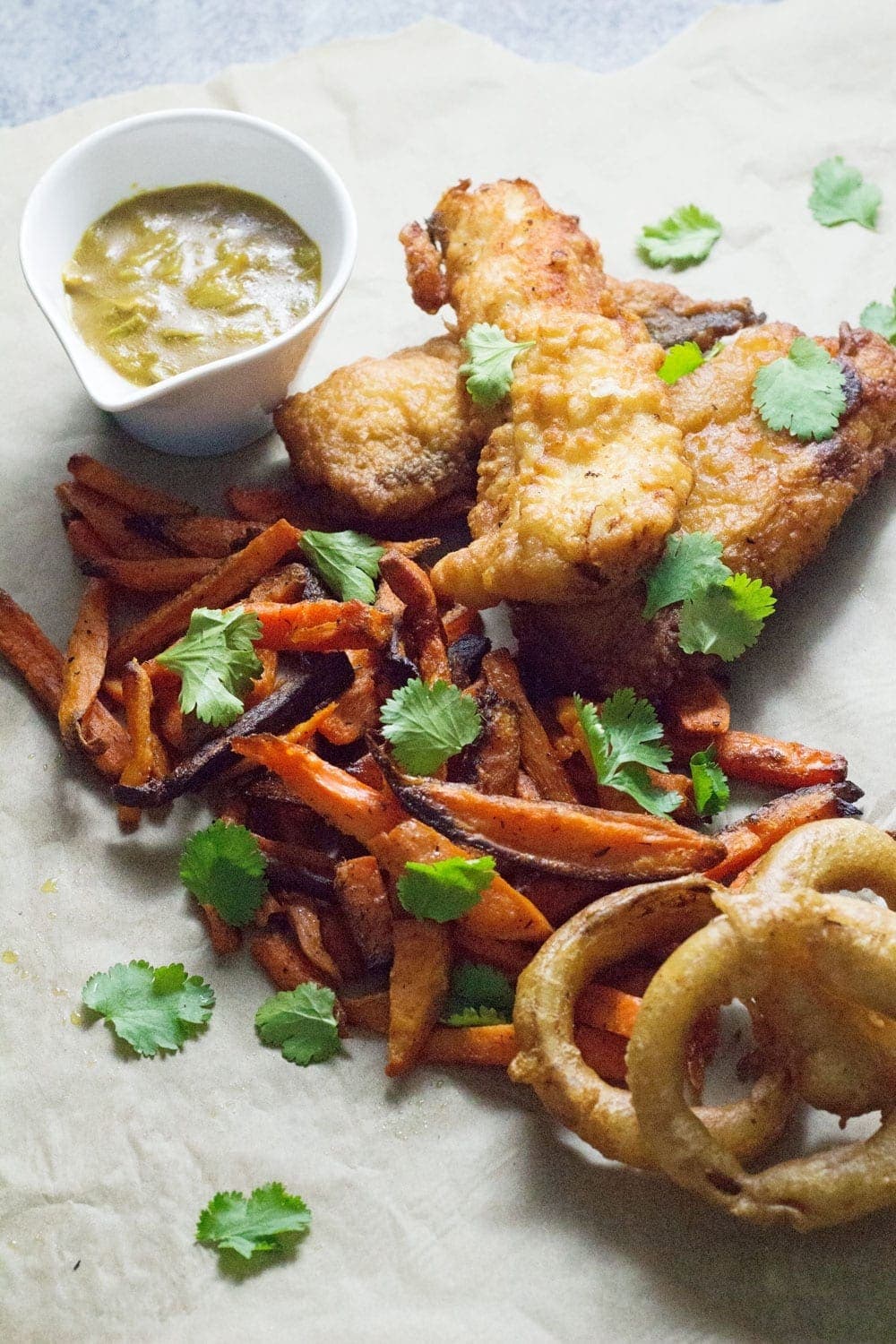 This Caribbean style fish and chips is made up of rum battered fish, sweet potato fries, jerk onion rings and an incredible coconut curry sauce!