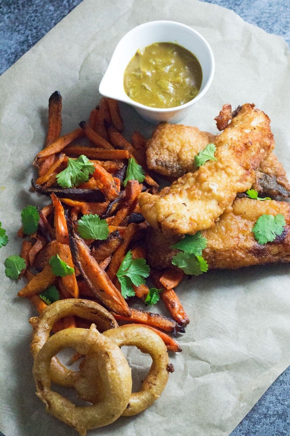 This Caribbean style fish and chips is made up of rum battered fish, sweet potato fries and an incredible coconut curry sauce!