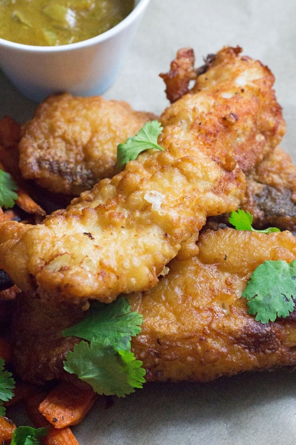 This Caribbean style fish and chips is made up of rum battered fish, sweet potato fries, jerk onion rings and an incredible coconut curry sauce!