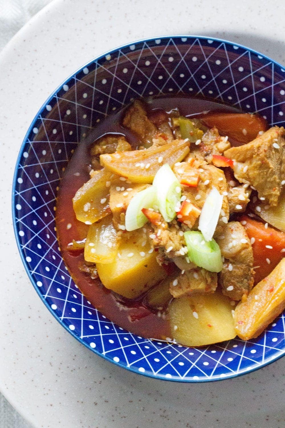 This Korean pork & potato stew is full of warm, spicy flavour. Slow cooking it makes the meat fall apart. It's the perfect winter warmer.