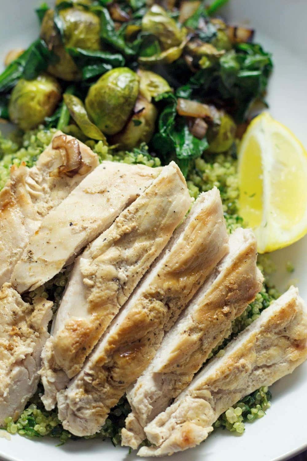 Looking for a delicious and healthy weeknight dinner? These healthy green quinoa bowls topped with chicken are the perfect thing!