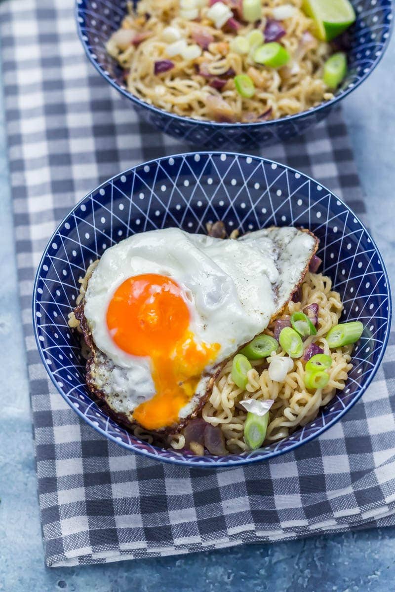 Noodles with a runny egg on a checked cloth