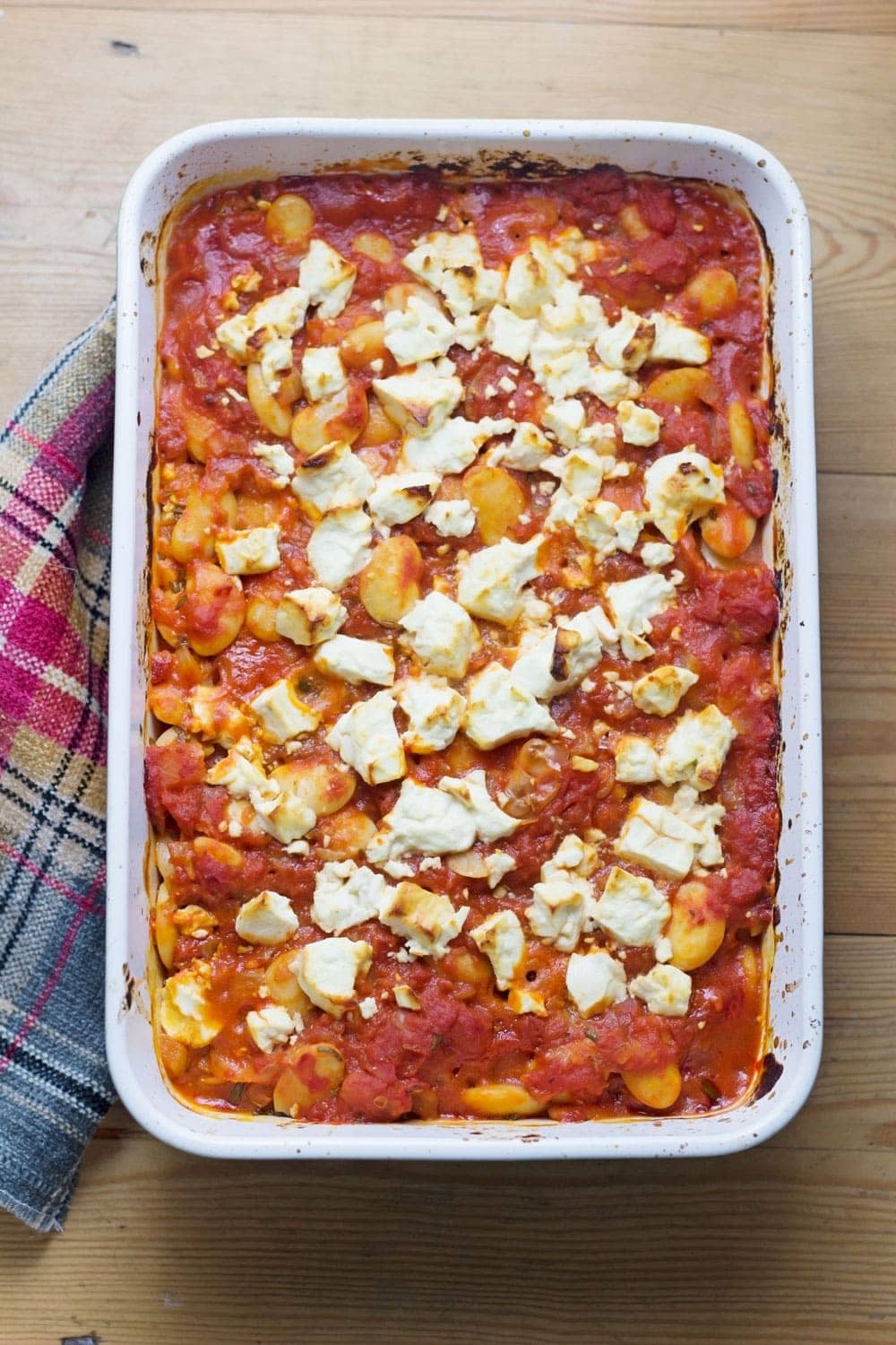 These baked white beans are cooked slowly with feta crumbled over the top then served with garlicky yoghurt and a drizzle of homemade chilli butter.