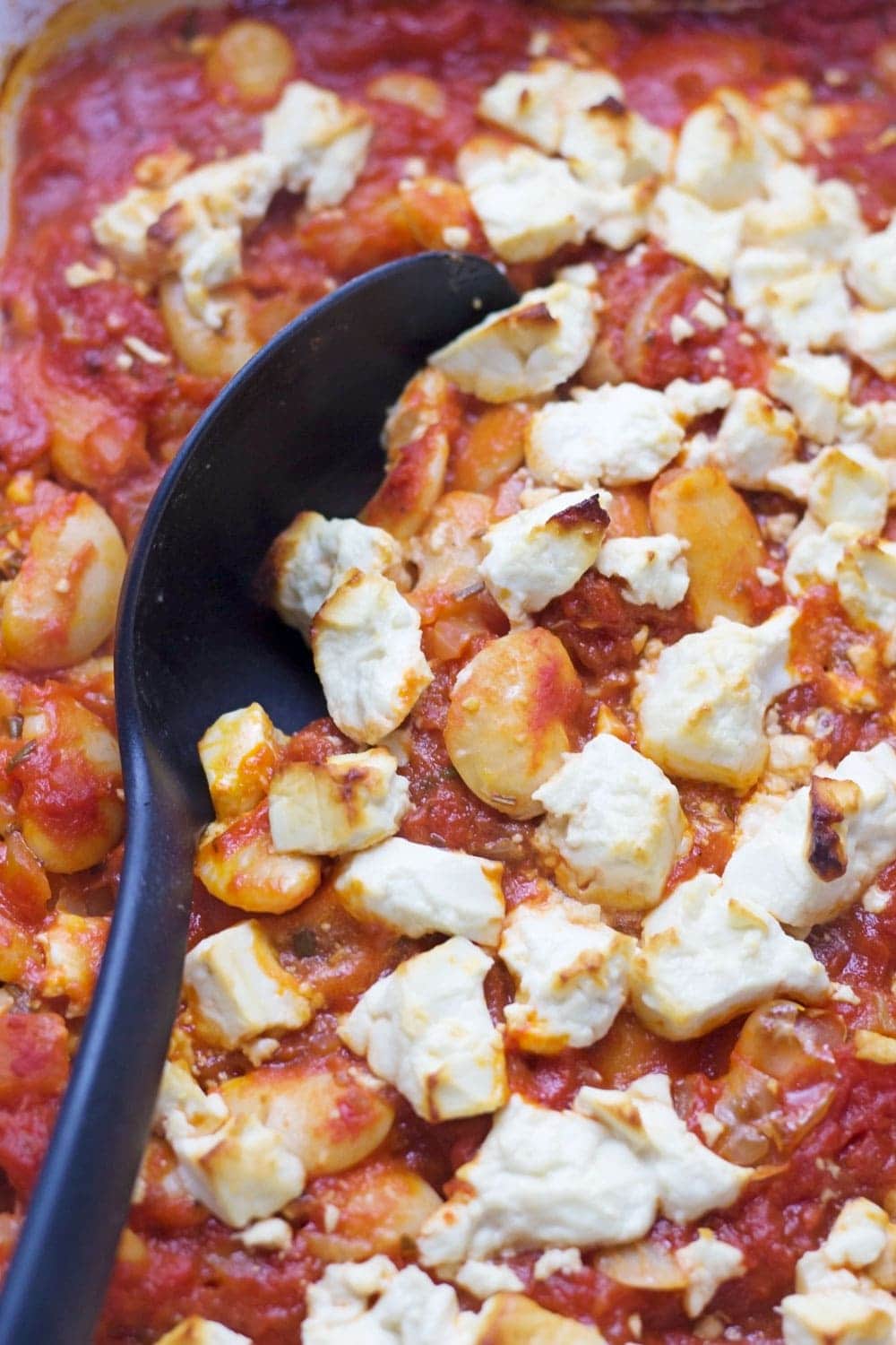 These baked white beans are cooked slowly with feta crumbled over the top then served with garlicky yoghurt and a drizzle of homemade paprika butter.