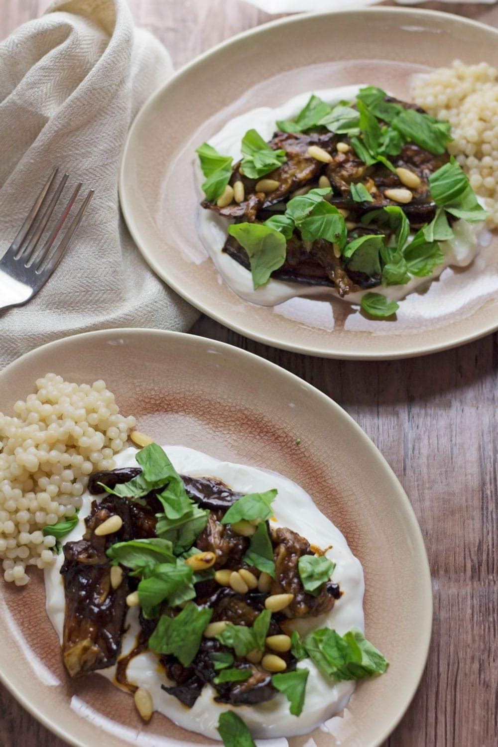 This roast aubergine gets a rich balsamic flavour from the black garlic cooled down by a bed of Greek yoghurt. Serve with Israeli couscous.