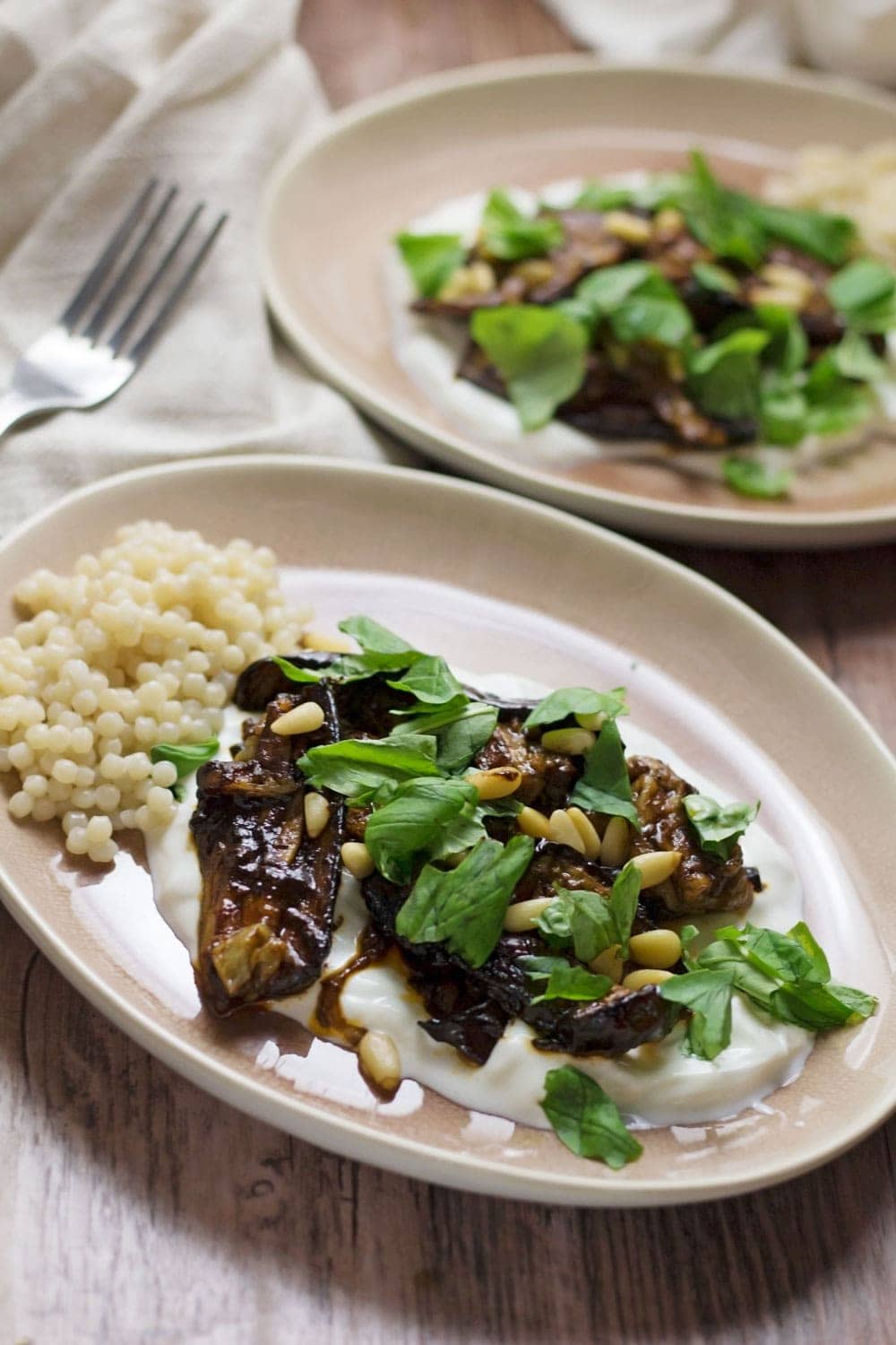 This roast aubergine gets a rich balsamic flavour from the black garlic cooled down by a bed of Greek yoghurt. Serve with Israeli couscous.