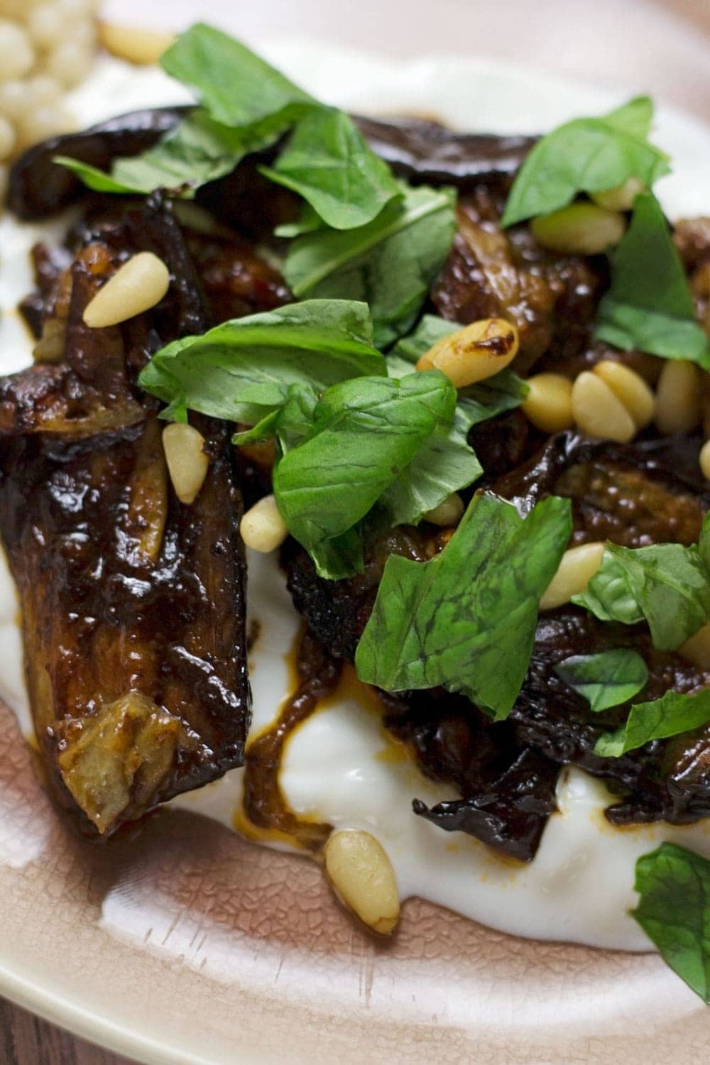 This roast aubergine gets a rich balsamic flavour from the black garlic cooled down by a bed of Greek yoghurt. Serve with Israeli couscous.