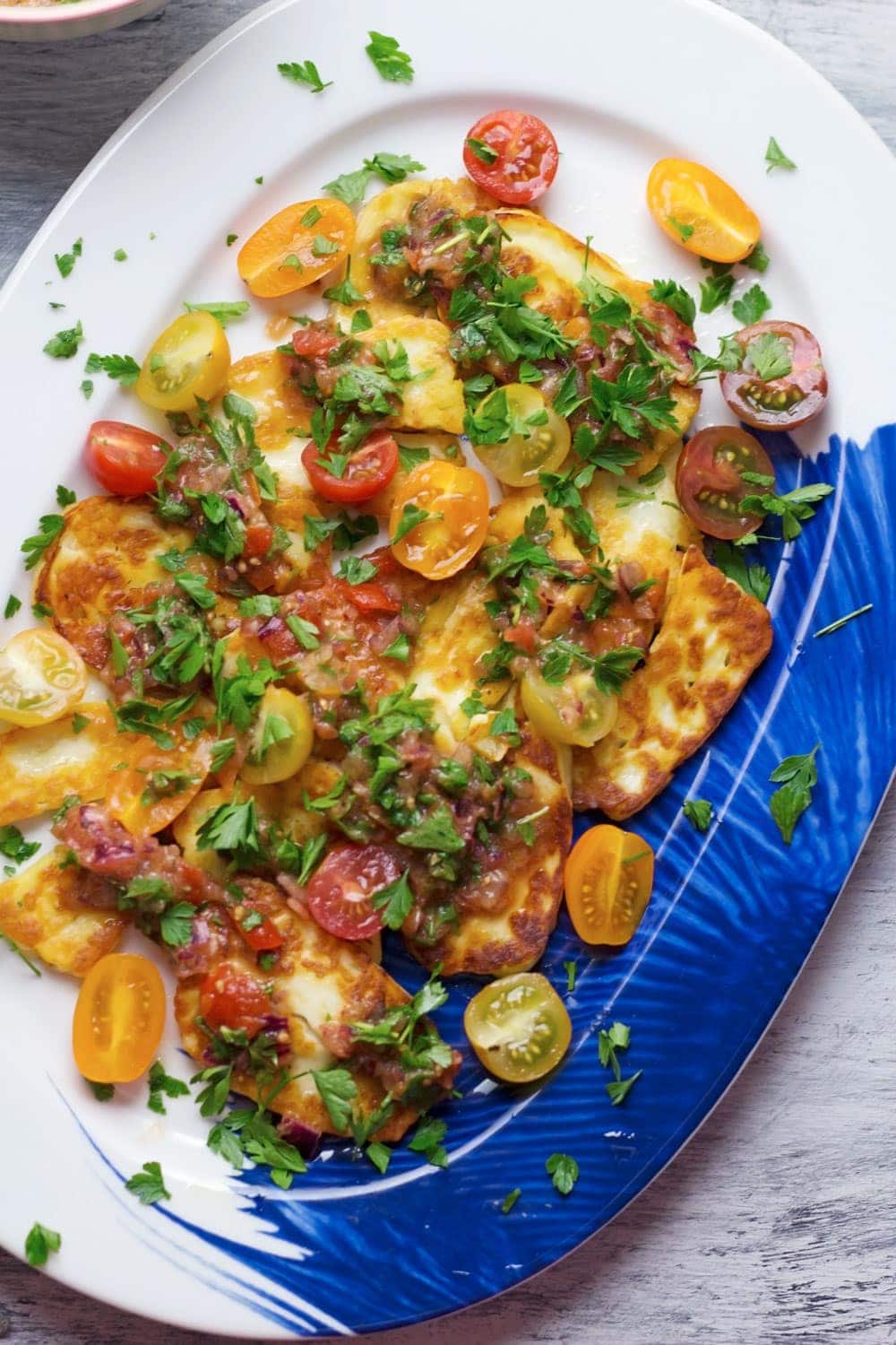 This grilled halloumi salad is topped with a beautiful herby tomato salsa. It's so easy to make and is the ultimate summer meal!