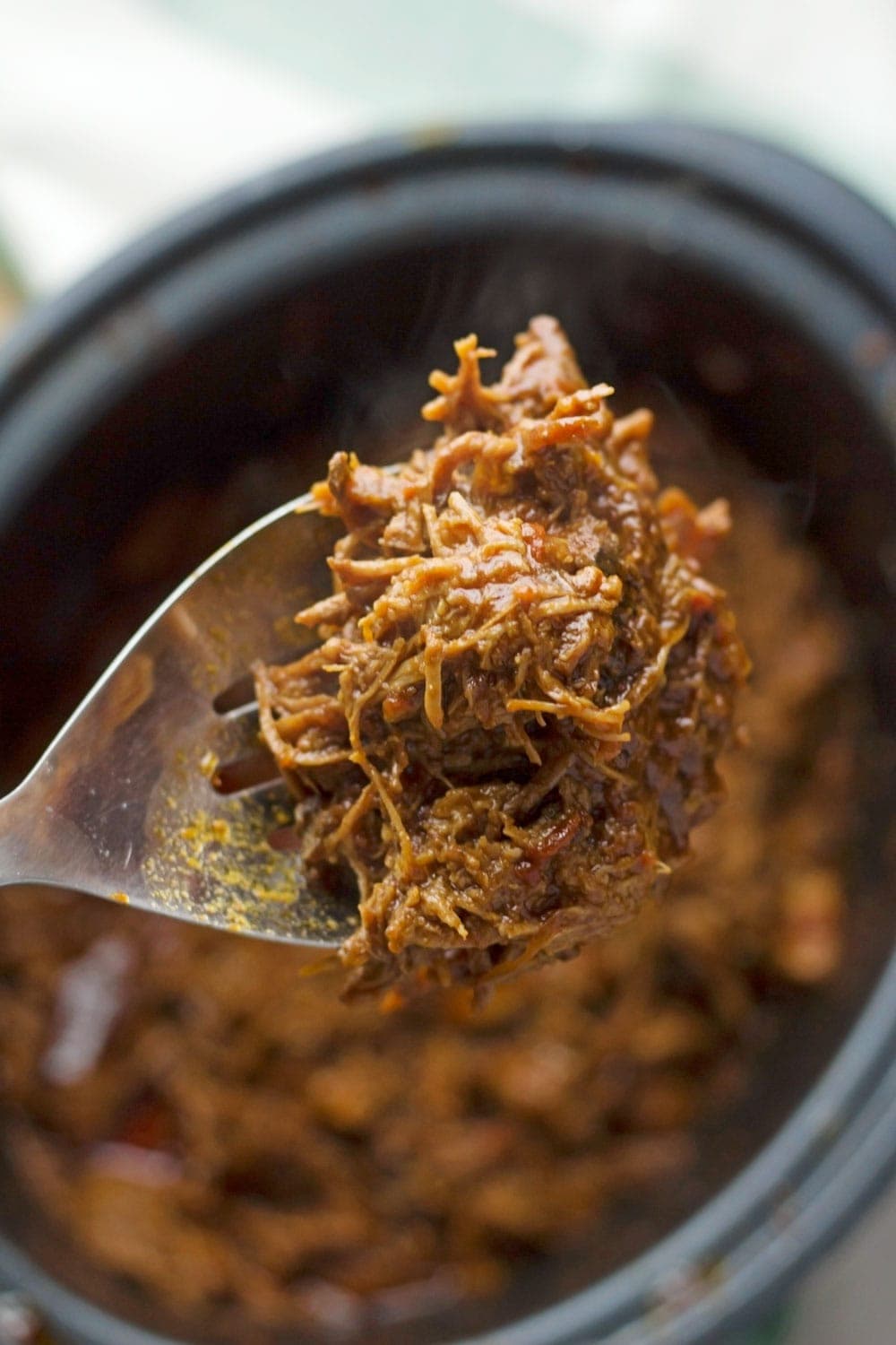 Beef brisket is slow cooked until meltingly tender for this spicy slow cooker pulled brisket. Serve in rolls or wraps for a delicious dinner!